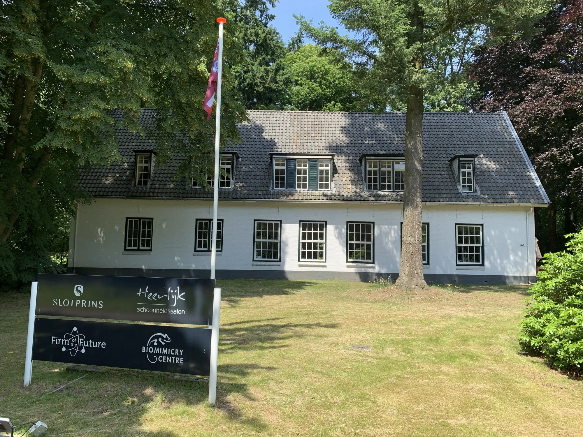 The building on the Utrechtseweg, seen from the road, with the name board in front